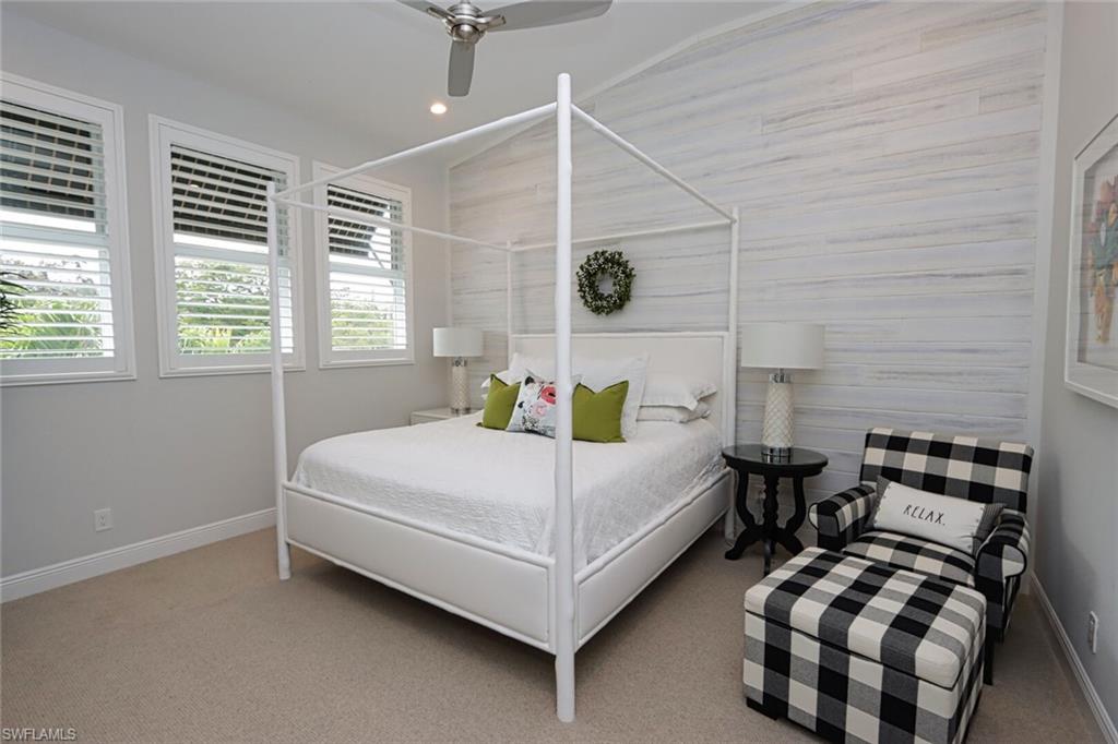 1165 4th Street South, Unit 2 Naples, FL 34102 - Photo 15 of 34 a bedroom with a bed lamp and window