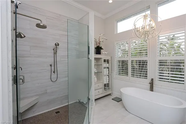a bathroom with a granite countertop tub shower and sink