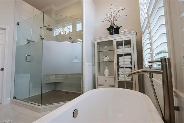 a bathroom with a granite countertop sink a mirror and shower