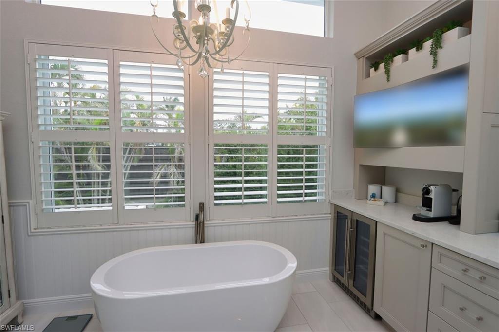 1165 4th Street South, Unit 2 Naples, FL 34102 - Photo 20 of 34 a bathroom with a bathtub a window and a vanity