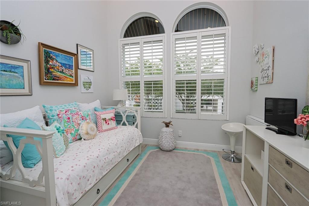 1165 4th Street South, Unit 2 Naples, FL 34102 - Photo 22 of 34 a living room with furniture and a flat screen tv