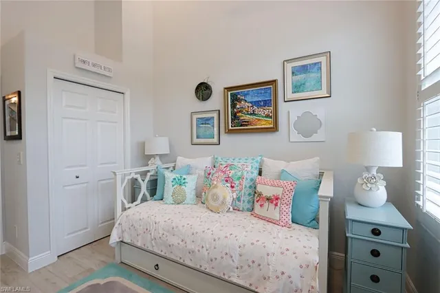 a bedroom with a bed and wall painting