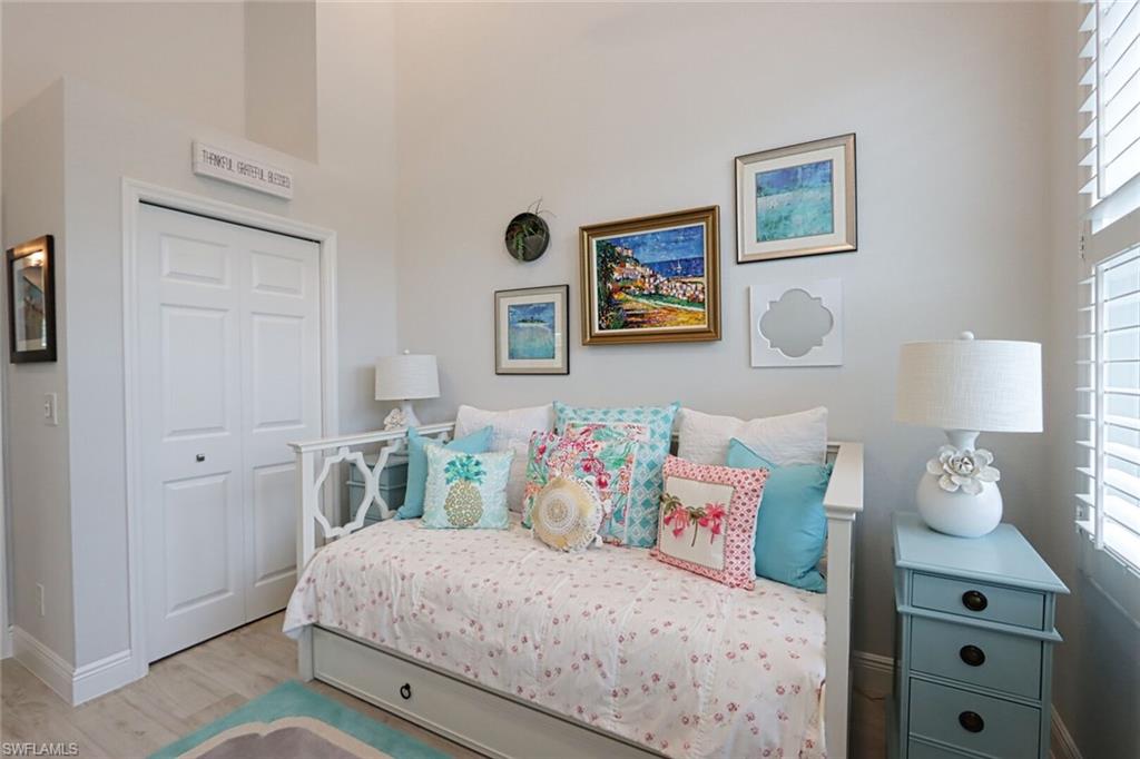 1165 4th Street South, Unit 2 Naples, FL 34102 - Photo 23 of 34 a bedroom with a bed and wall painting