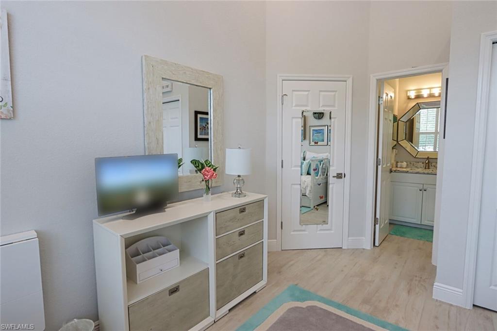 1165 4th Street South, Unit 2 Naples, FL 34102 - Photo 24 of 34 a living room with furniture and a flat screen tv