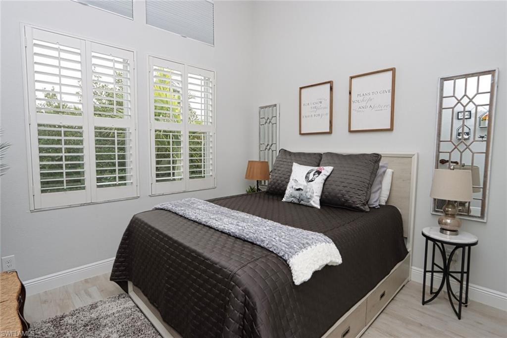 1165 4th Street South, Unit 2 Naples, FL 34102 - Photo 26 of 34 a bedroom with a bed and a window