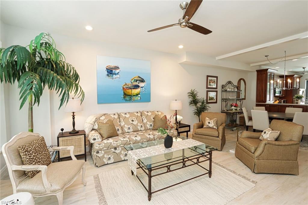 1165 4th Street South, Unit 2 Naples, FL 34102 - Photo 3 of 34 a living room with furniture and a potted plant
