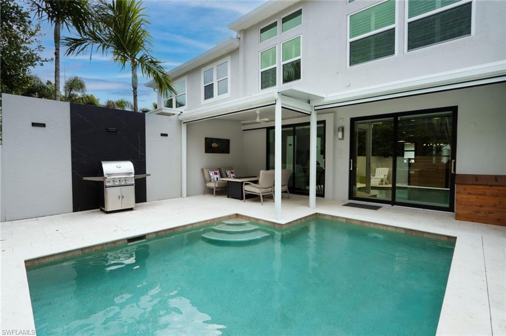 1165 4th Street South, Unit 2 Naples, FL 34102 - Photo 31 of 34 a house view with a garden space