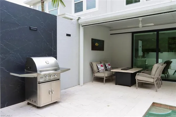 a roof deck with table and chairs