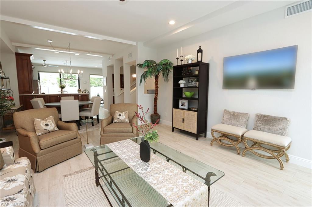 1165 4th Street South, Unit 2 Naples, FL 34102 - Photo 4 of 34 a living room with furniture and a flat screen tv