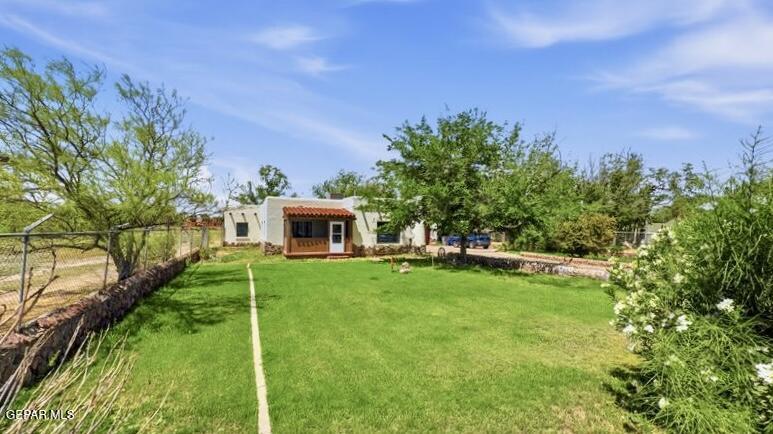 4135 Emory Road El Paso, TX 79922 - Photo 13 of 73 a backyard of a house with table and chairs plants and large trees
