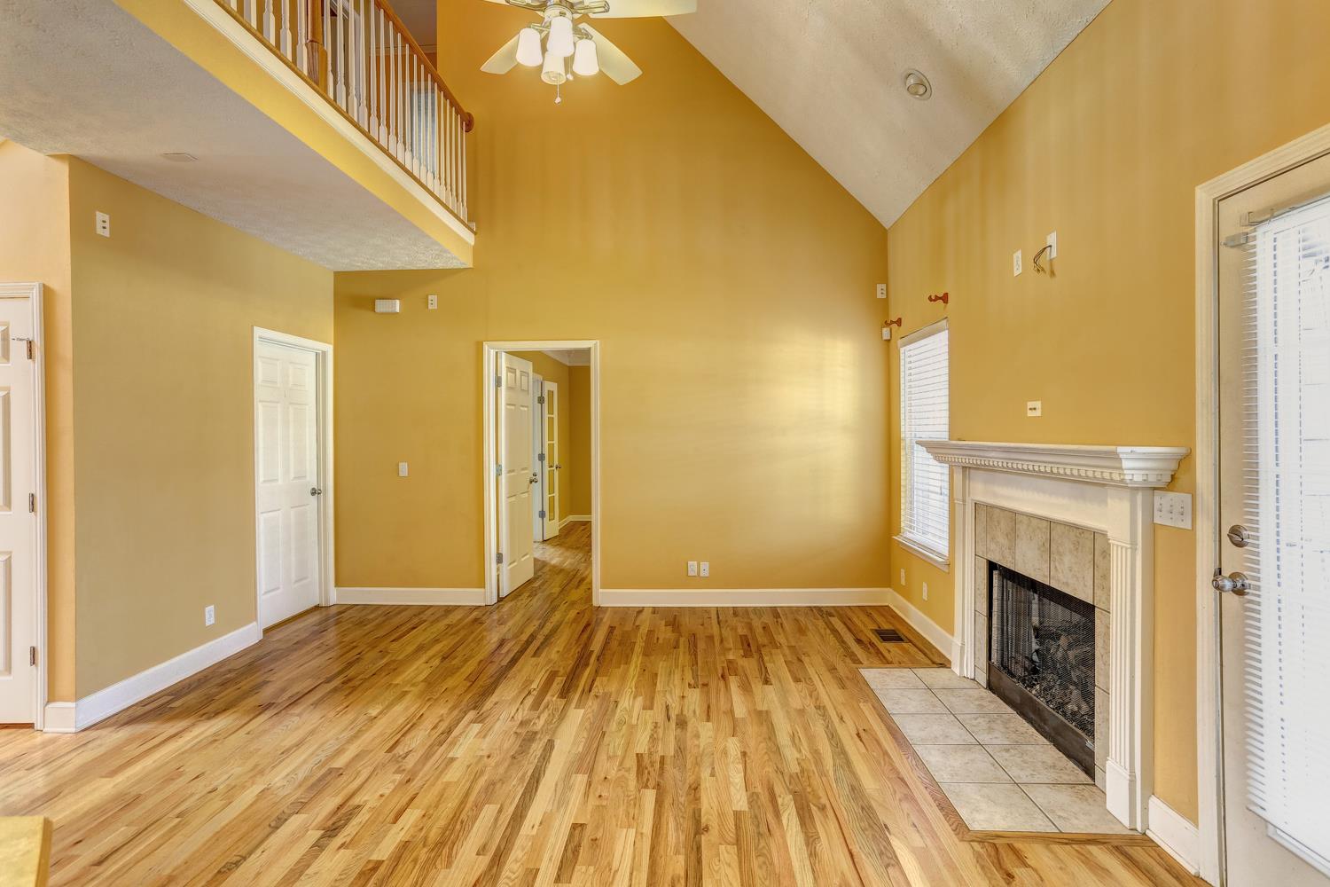 2969 Indian Ridge Boulevard White House, TN 37188 - Photo 6 of 29 a view of a livingroom with wooden floor and a fireplace