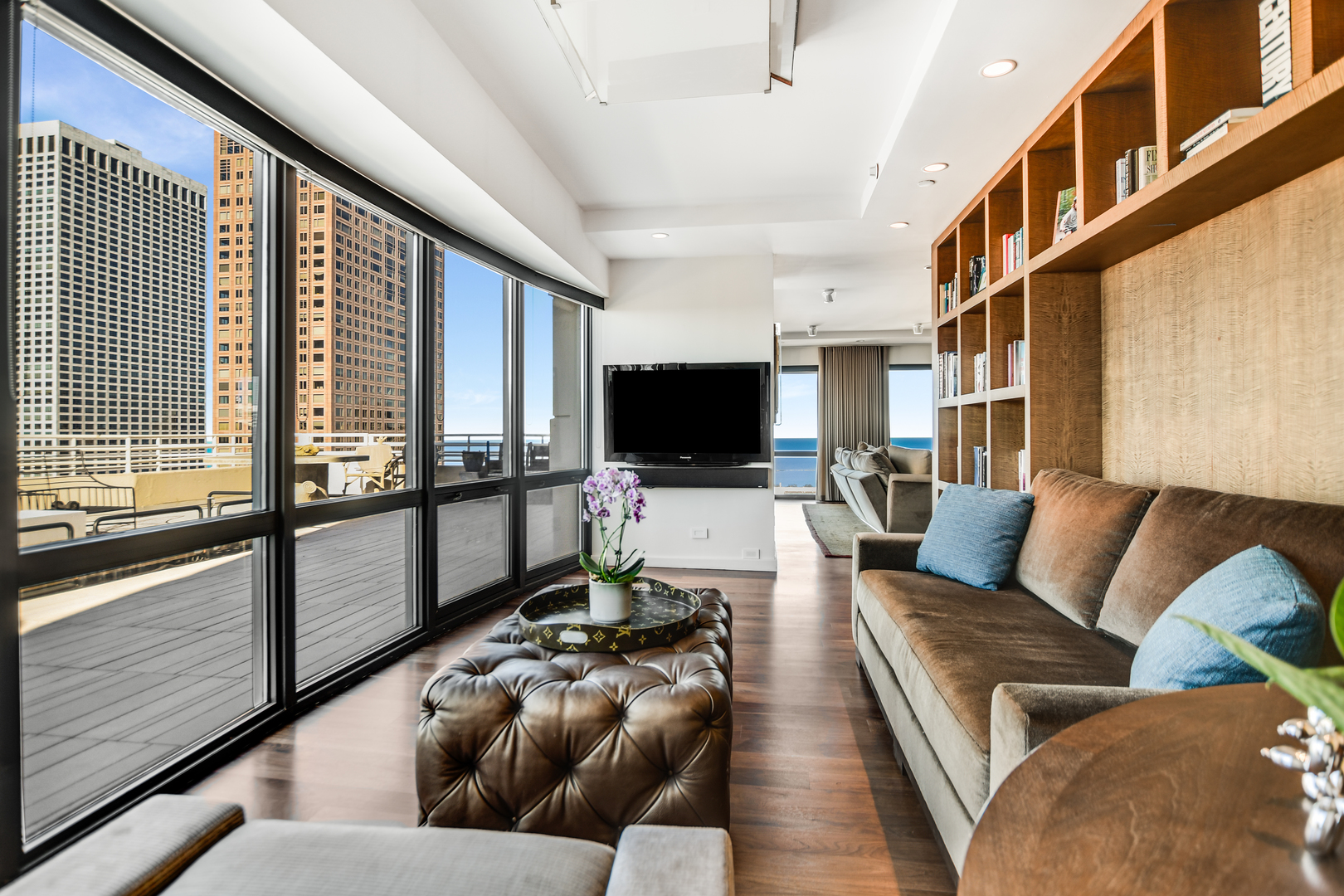 100 East Huron Street, Unit 4002 Chicago, IL 60611 - Photo 12 of 49 a living room with furniture and a flat screen tv