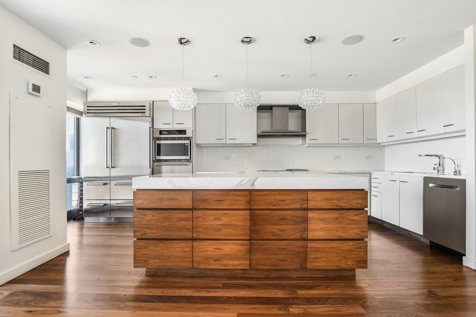 100 East Huron Street, Unit 4002 Chicago, IL 60611 - Photo 16 of 49 a kitchen with stainless steel appliances granite countertop a stove and white cabinets