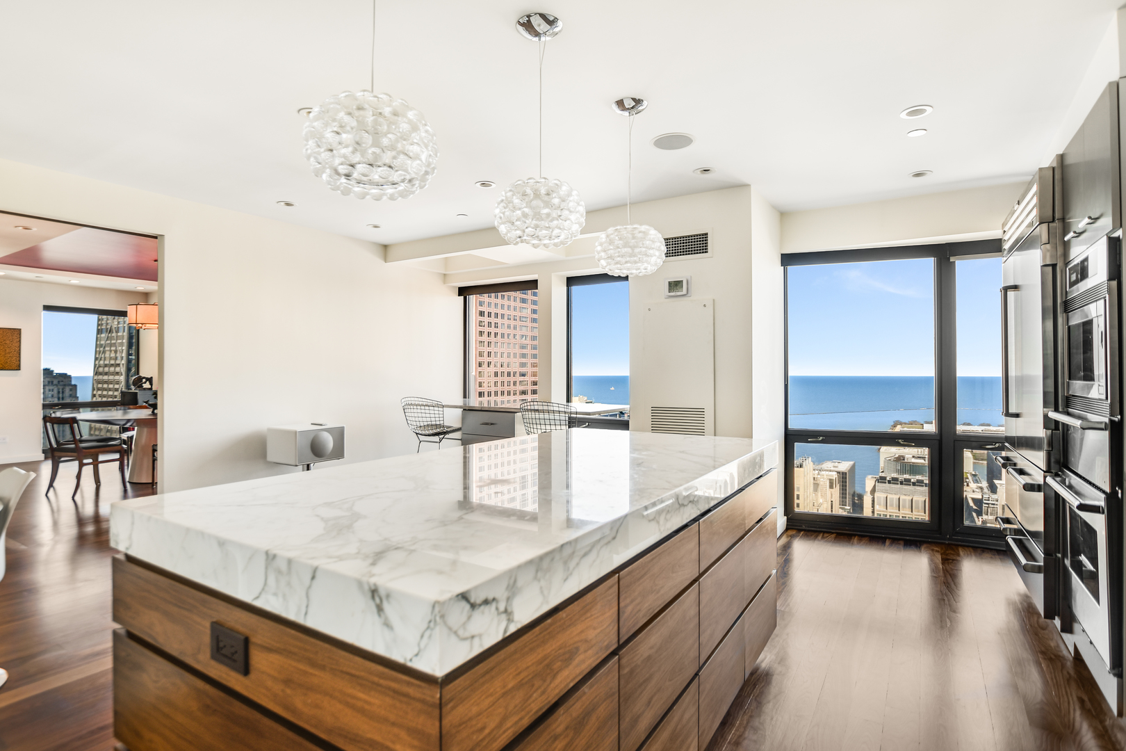 100 East Huron Street, Unit 4002 Chicago, IL 60611 - Photo 17 of 49 a kitchen with stainless steel appliances granite countertop a kitchen island a stove and a dining table