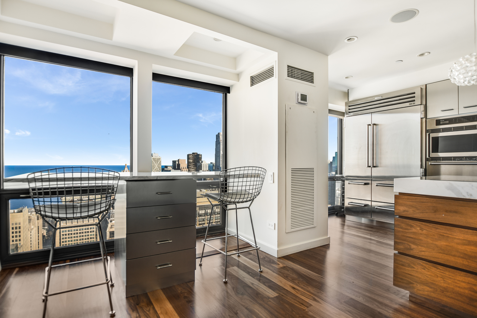 100 East Huron Street, Unit 4002 Chicago, IL 60611 - Photo 18 of 49 a view of living room kitchen with stainless steel appliances wooden floor and chair
