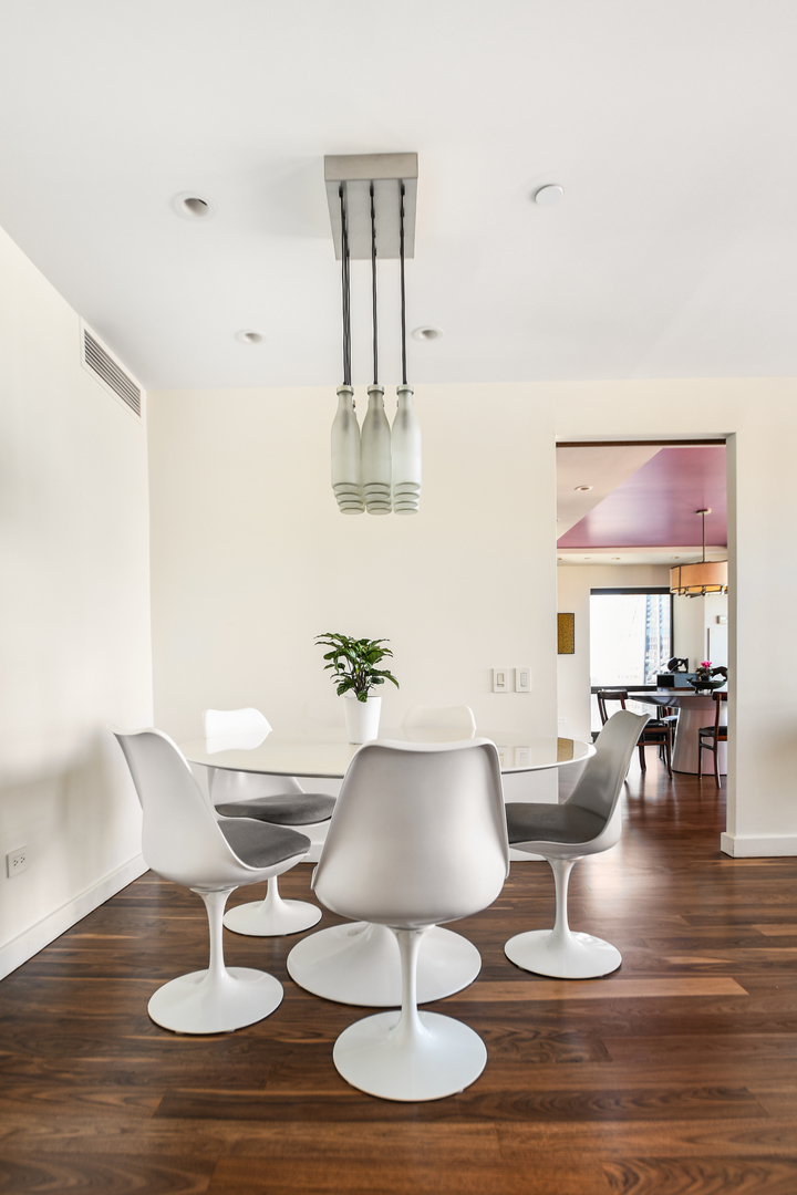 100 East Huron Street, Unit 4002 Chicago, IL 60611 - Photo 20 of 49 a living room with furniture and wooden floor