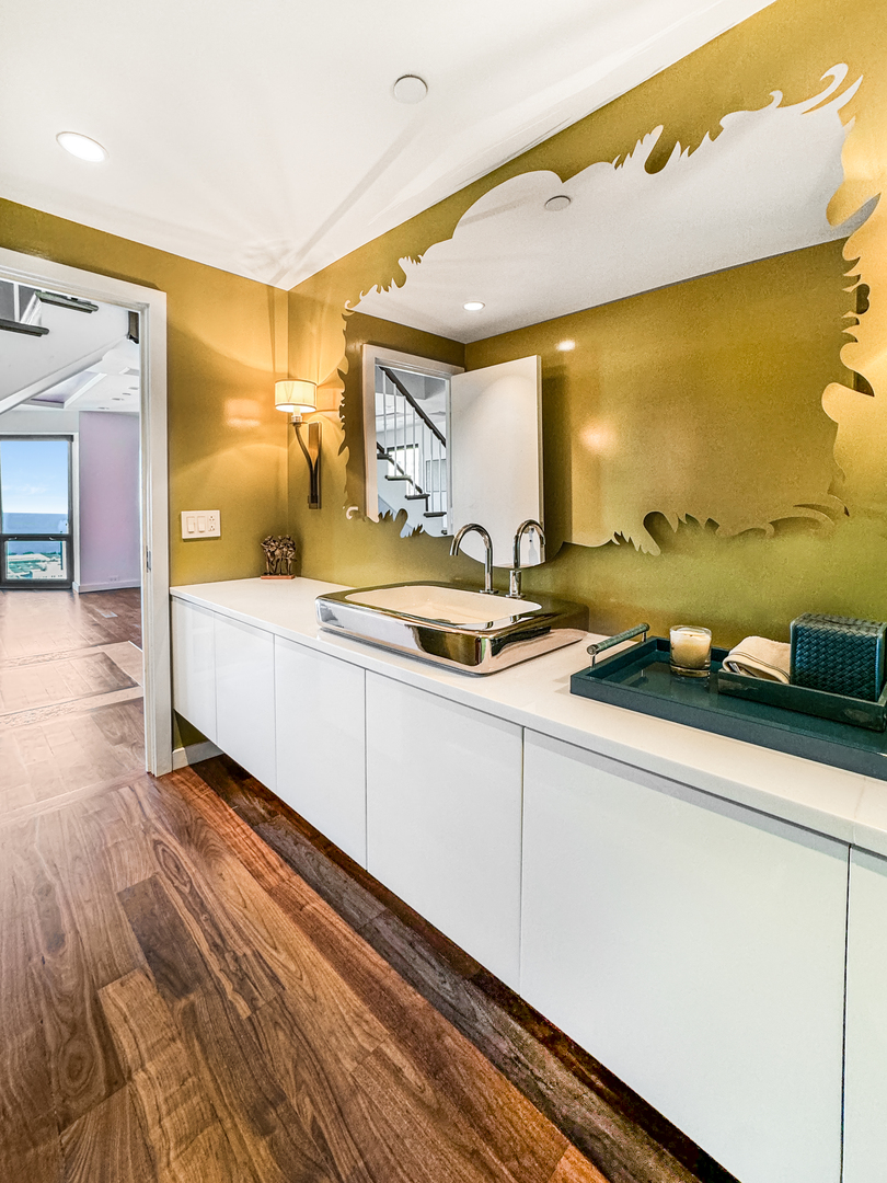 100 East Huron Street, Unit 4002 Chicago, IL 60611 - Photo 22 of 49 a spacious bathroom with a sink and a mirror