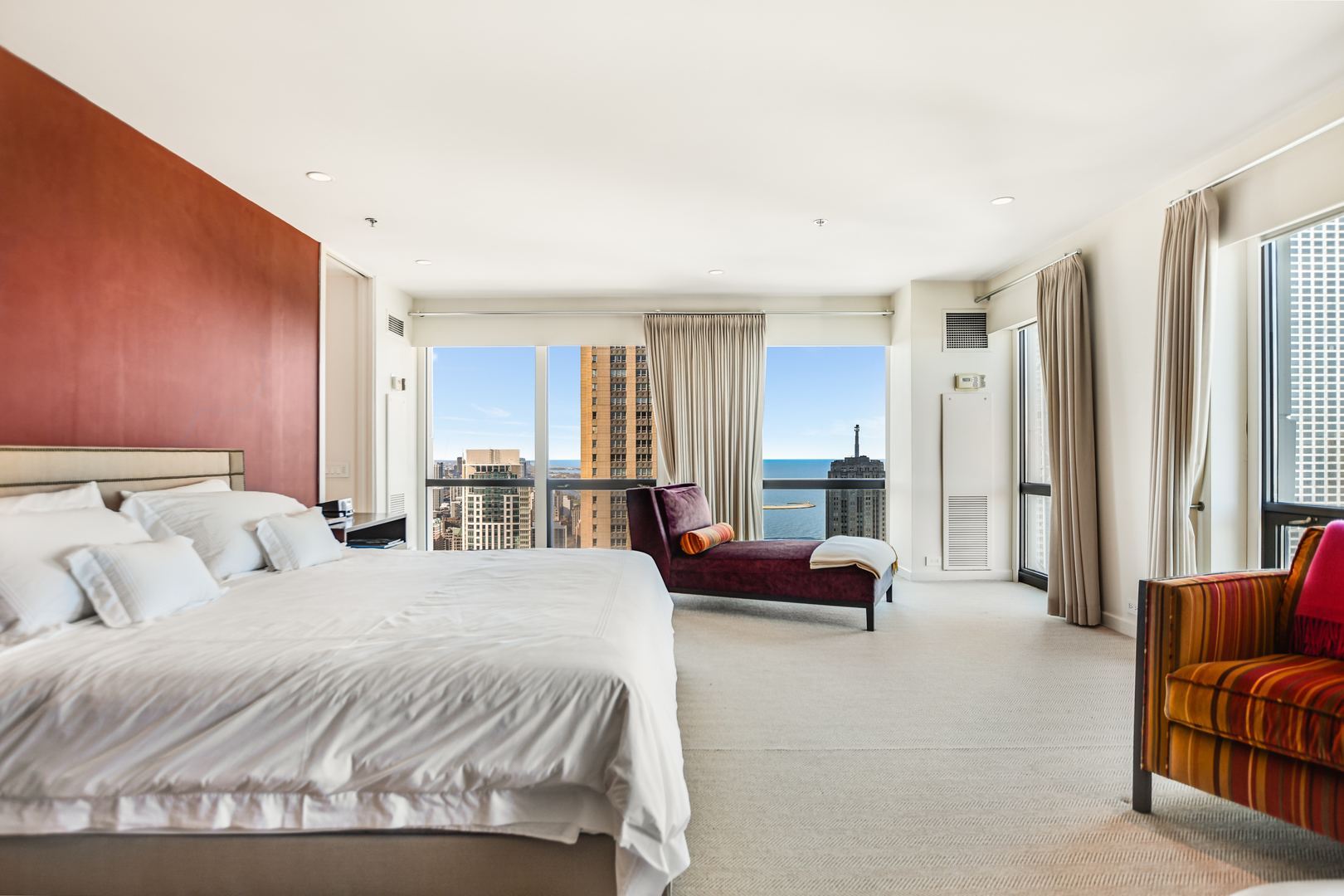 100 East Huron Street, Unit 4002 Chicago, IL 60611 - Photo 26 of 49 a spacious bedroom with a bed and a couch