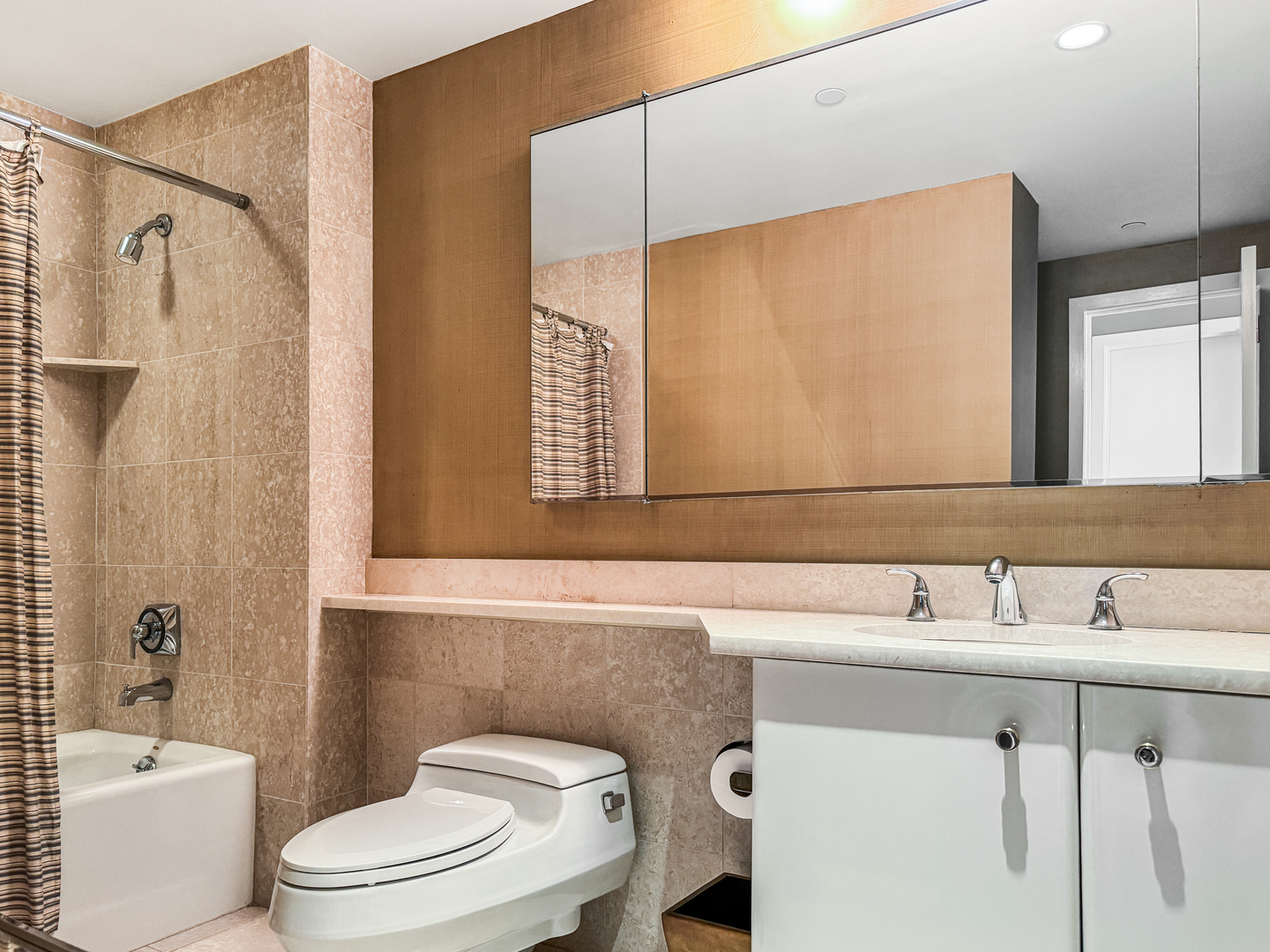 100 East Huron Street, Unit 4002 Chicago, IL 60611 - Photo 39 of 49 a bathroom with a sink a toilet and a mirror