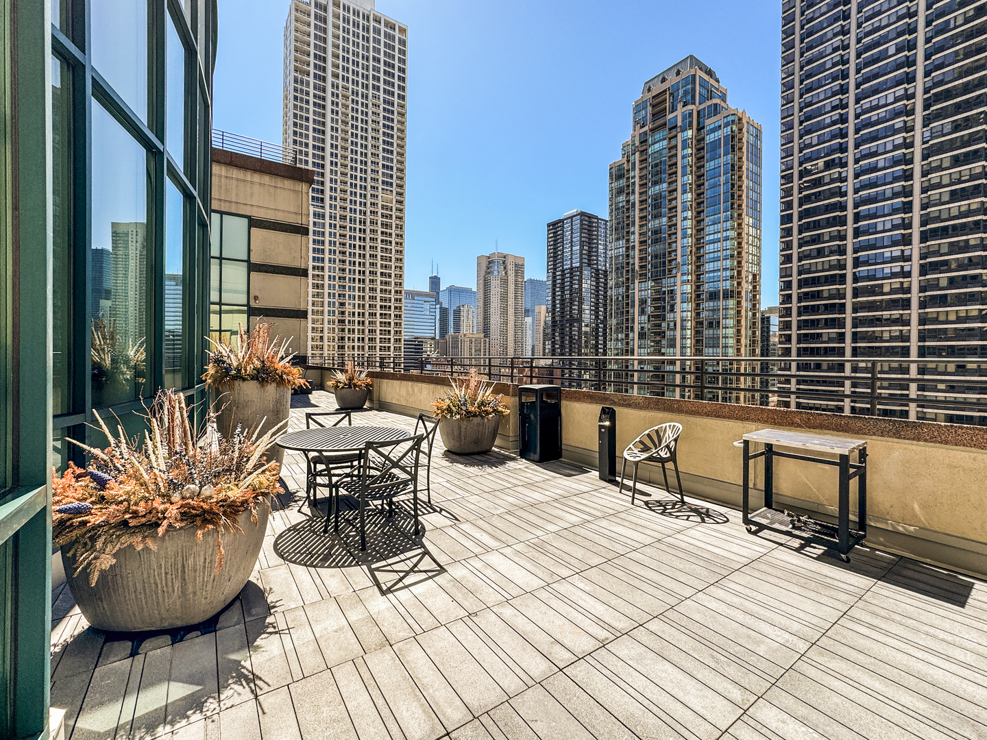 100 East Huron Street, Unit 4002 Chicago, IL 60611 - Photo 44 of 49 a roof deck with outdoor seating and city view