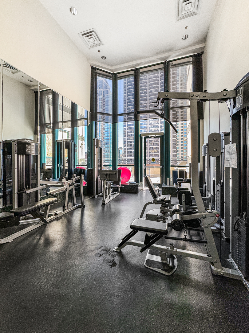100 East Huron Street, Unit 4002 Chicago, IL 60611 - Photo 46 of 49 a room with gym equipment and a large window