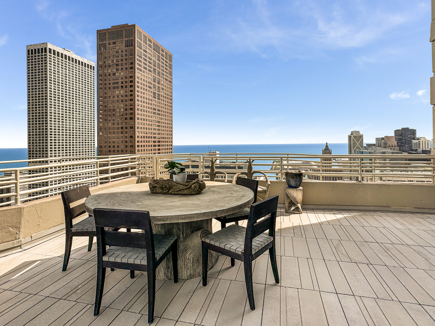 100 East Huron Street, Unit 4002 Chicago, IL 60611 - Photo 9 of 49 a view of a roof deck with table and chairs