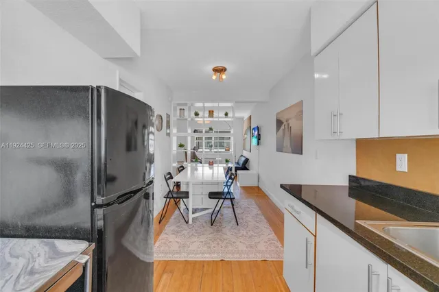 a kitchen with stainless steel appliances granite countertop a sink refrigerator and microwave