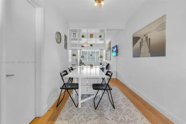 a view of a room with furniture and wooden floor