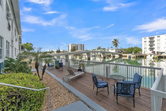 a view of a chairs and table in patio with a lake view