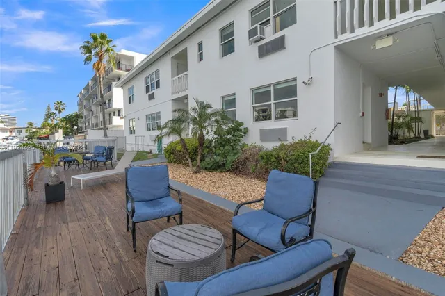 a view of balcony with furniture and a potted plant