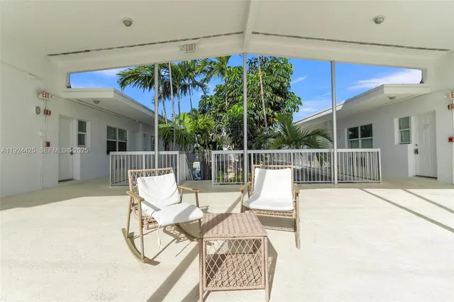 a view of a chair and tables in patio of the house