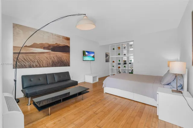 a bedroom with a bed and a mirror