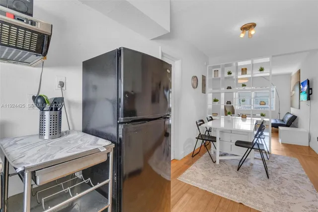 a dining room with furniture and wooden floor