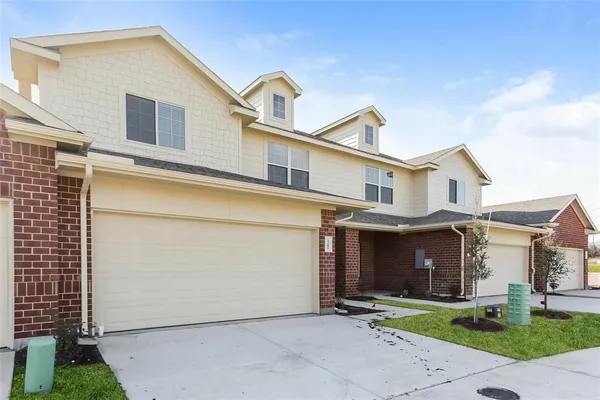 a view of a house with a yard and garage