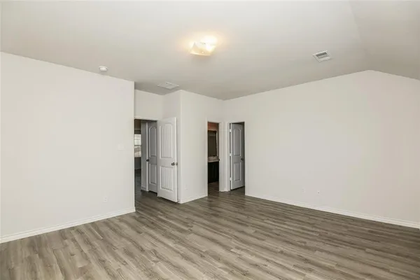 a bathroom with a granite countertop sink a toilet a mirror and bathtub