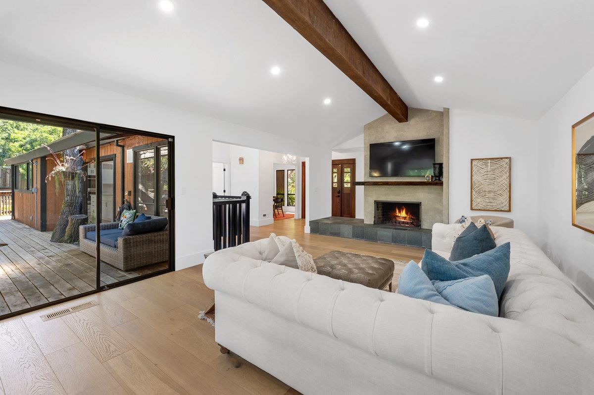 27 Oakwood Road Orinda, CA 94563 - Photo 10 of 61 a living room with furniture a fireplace and a flat screen tv