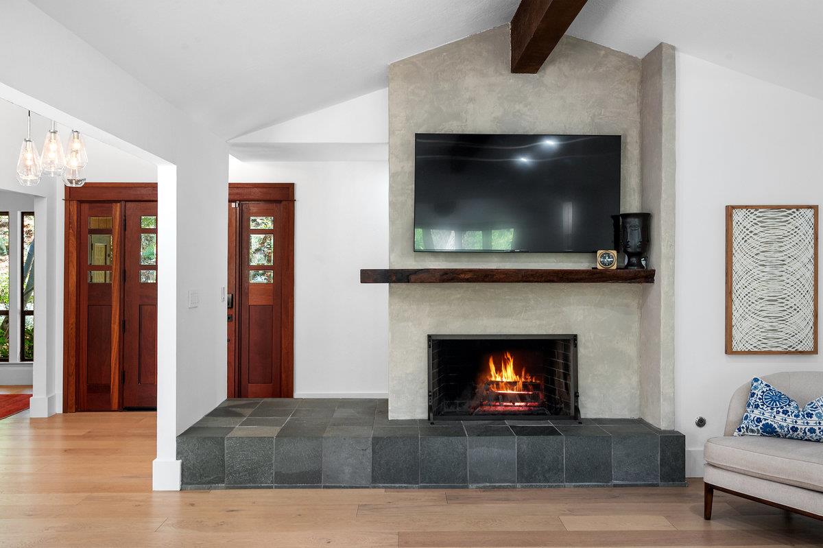 27 Oakwood Road Orinda, CA 94563 - Photo 11 of 61 a living room with furniture a fireplace and a flat screen tv