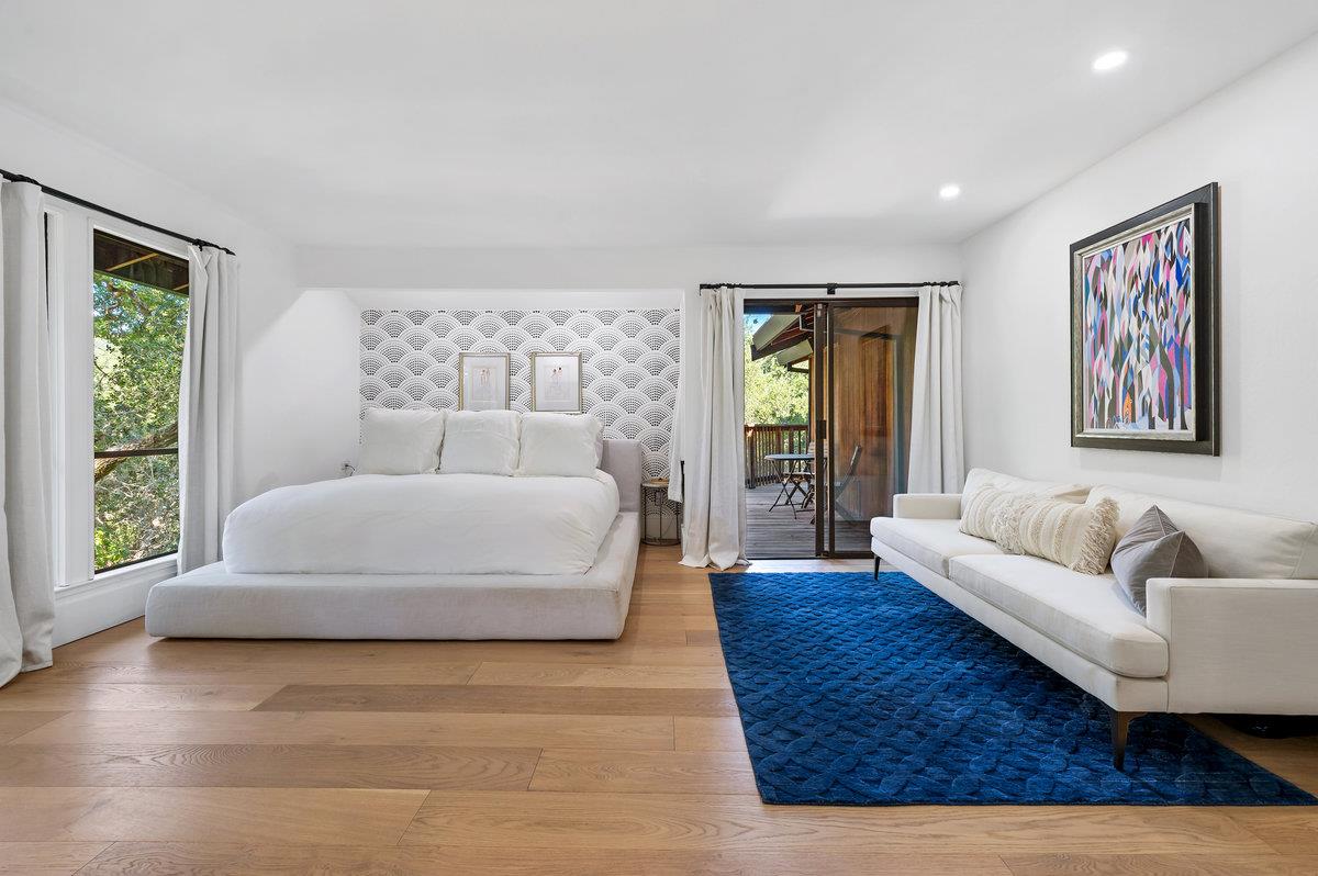 27 Oakwood Road Orinda, CA 94563 - Photo 30 of 61 a spacious bedroom with a bed couch and a large window