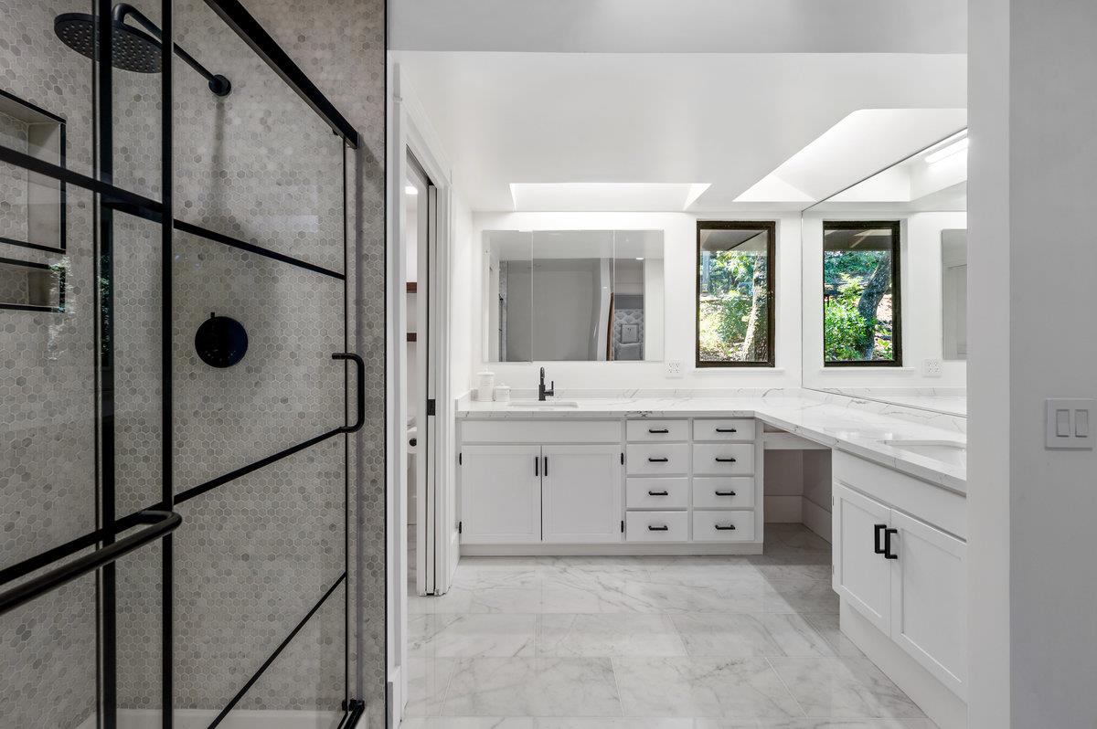 27 Oakwood Road Orinda, CA 94563 - Photo 32 of 61 a spacious bathroom with a granite countertop sink mirror and a bathtub