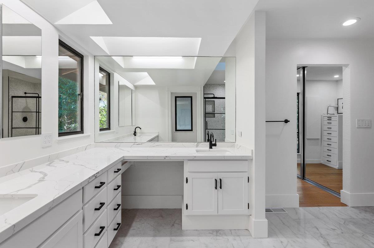 27 Oakwood Road Orinda, CA 94563 - Photo 34 of 61 a spacious bathroom with a double vanity sink a large mirror and a shower
