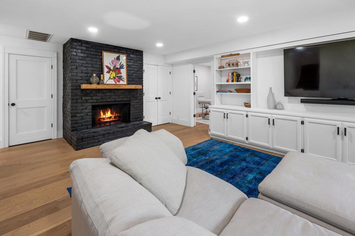 27 Oakwood Road Orinda, CA 94563 - Photo 39 of 61 a living room with furniture a flat screen tv and a fireplace