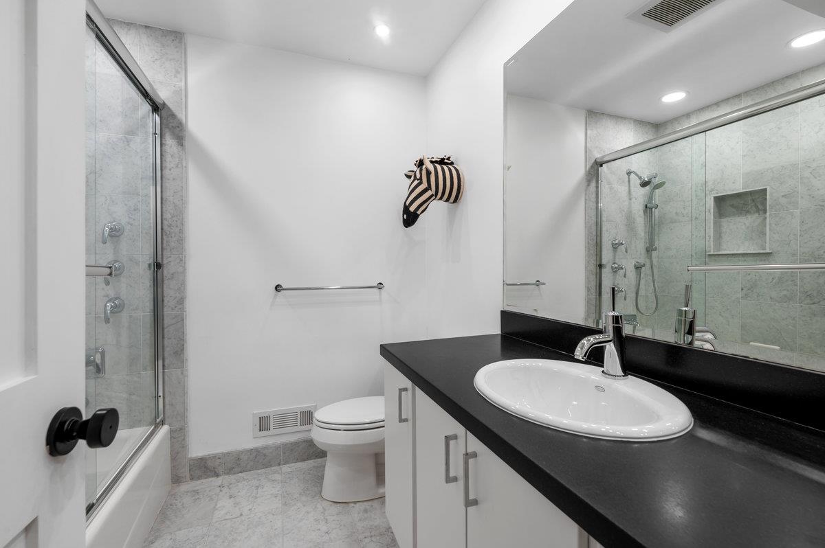27 Oakwood Road Orinda, CA 94563 - Photo 43 of 61 a bathroom with a sink a toilet a mirror and shower