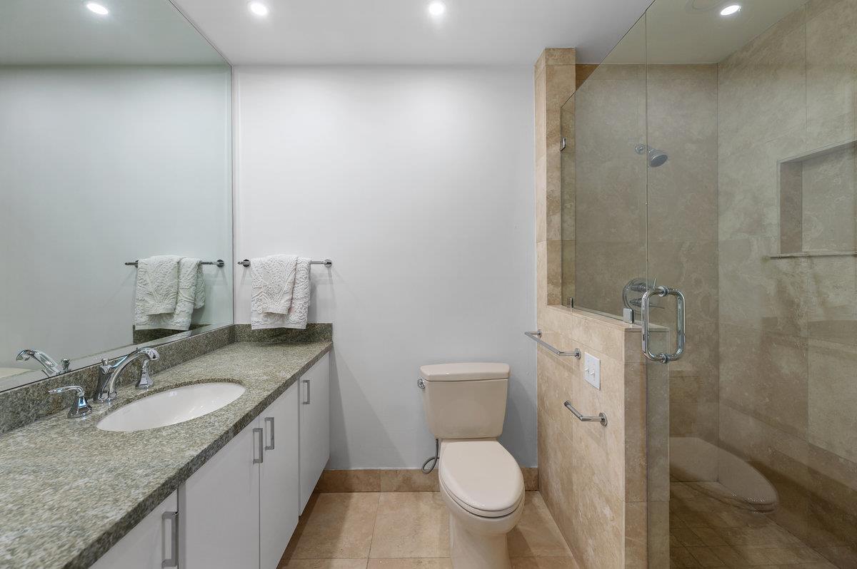 27 Oakwood Road Orinda, CA 94563 - Photo 46 of 61 a bathroom with a granite countertop sink a toilet and a shower
