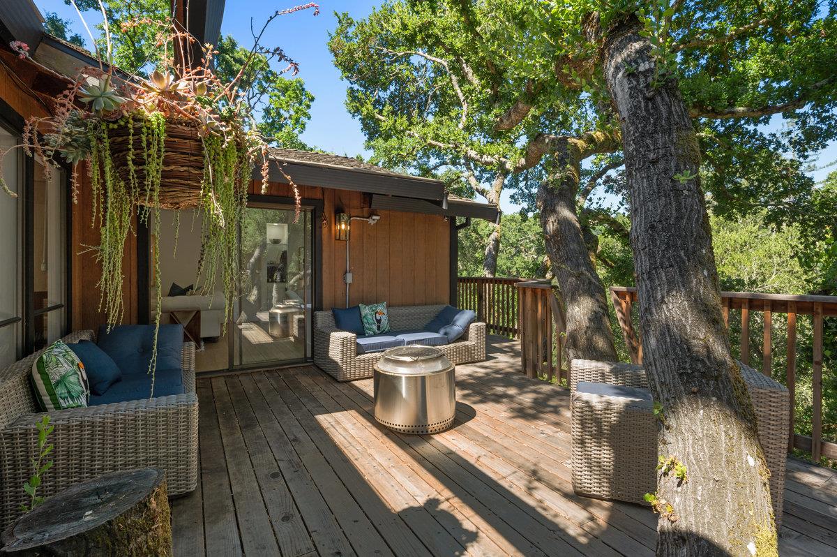 27 Oakwood Road Orinda, CA 94563 - Photo 48 of 61 a view of a patio with couches chairs and a table and chairs with wooden fence