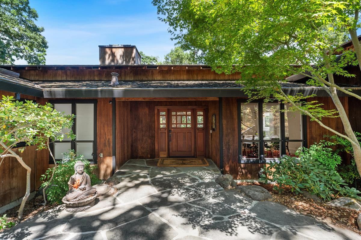 27 Oakwood Road Orinda, CA 94563 - Photo 4 of 61 a view of a house with potted plants and a large tree