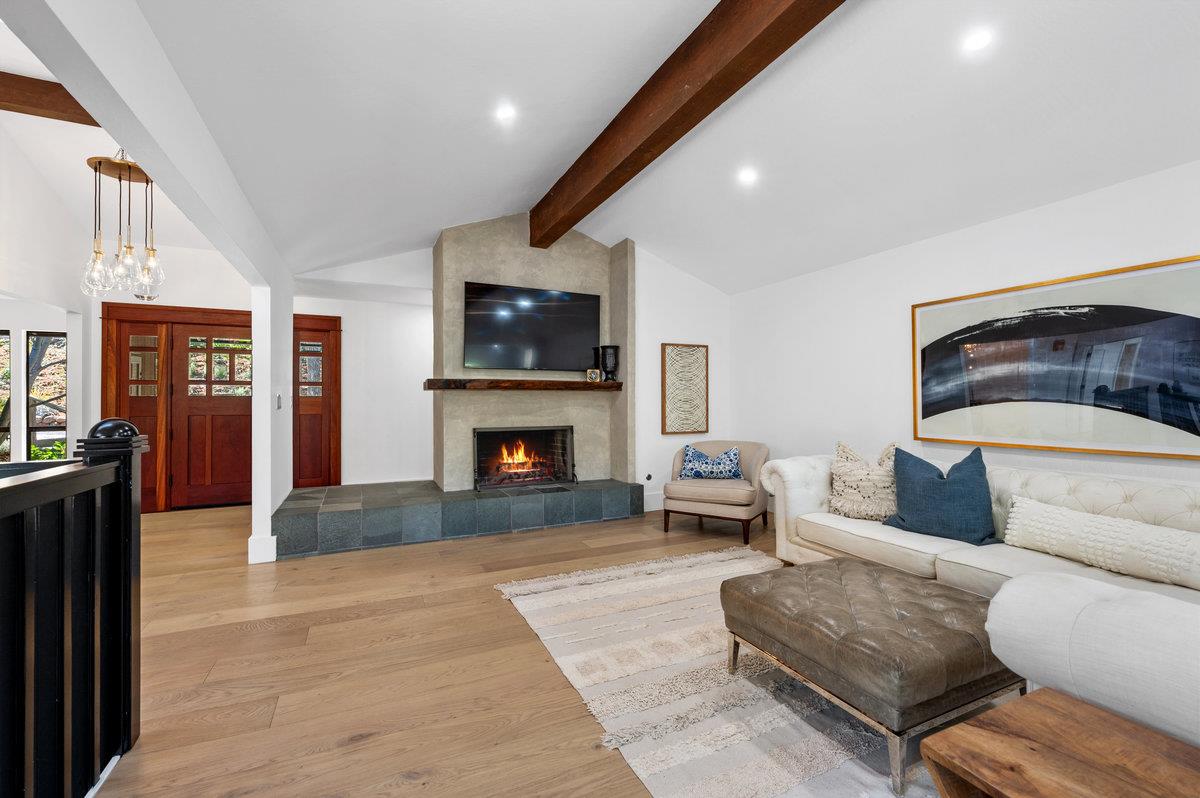 27 Oakwood Road Orinda, CA 94563 - Photo 6 of 61 a living room with furniture a flat screen tv and a fireplace