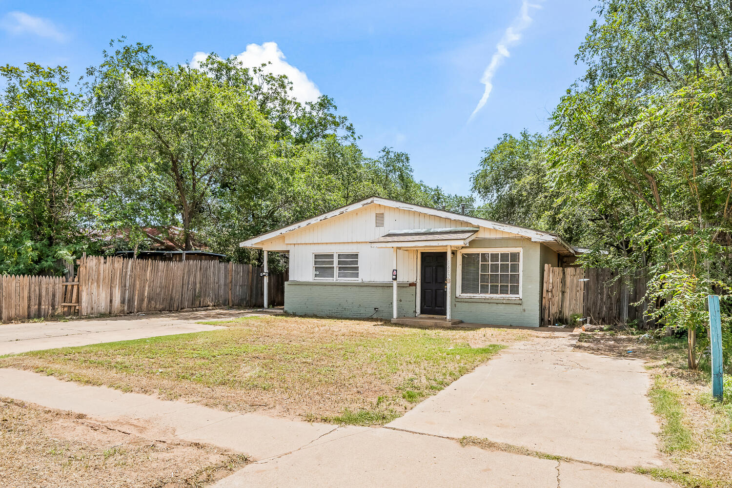 1603 27th Street, Unit B Lubbock, TX 79411 - Photo 13 of 13 a front view of a house with a yard