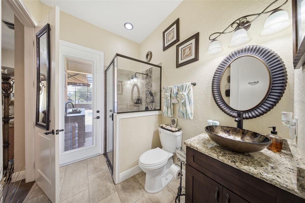13429 Montevista Road Clermont, FL 34711 - Photo 42 of 89 a bathroom with a granite countertop sink mirror vanity and toilet