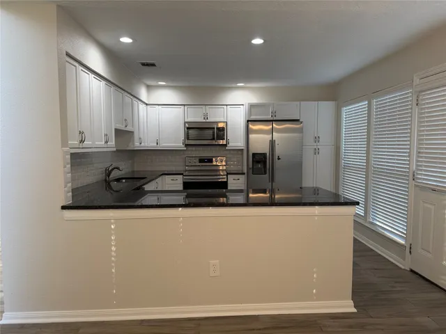 a view of a kitchen with electric appliances