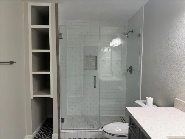 a bathroom with a sink toilet and shower